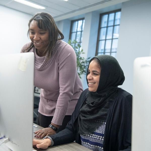 two female students working together at a computer